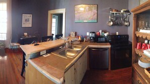 A kitchen with a refrigerator, sink, and dining area. - Historic, quiet, elegant, mix of modern & original (Dubuque)