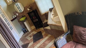 A bathroom with a sink, mirror, and a black cabinet. - Historic, quiet, elegant, mix of modern & original (Dubuque)