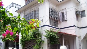A two-story building with a balcony and barred windows. - Blue Chip Guest House Kolkata (Kolkata)