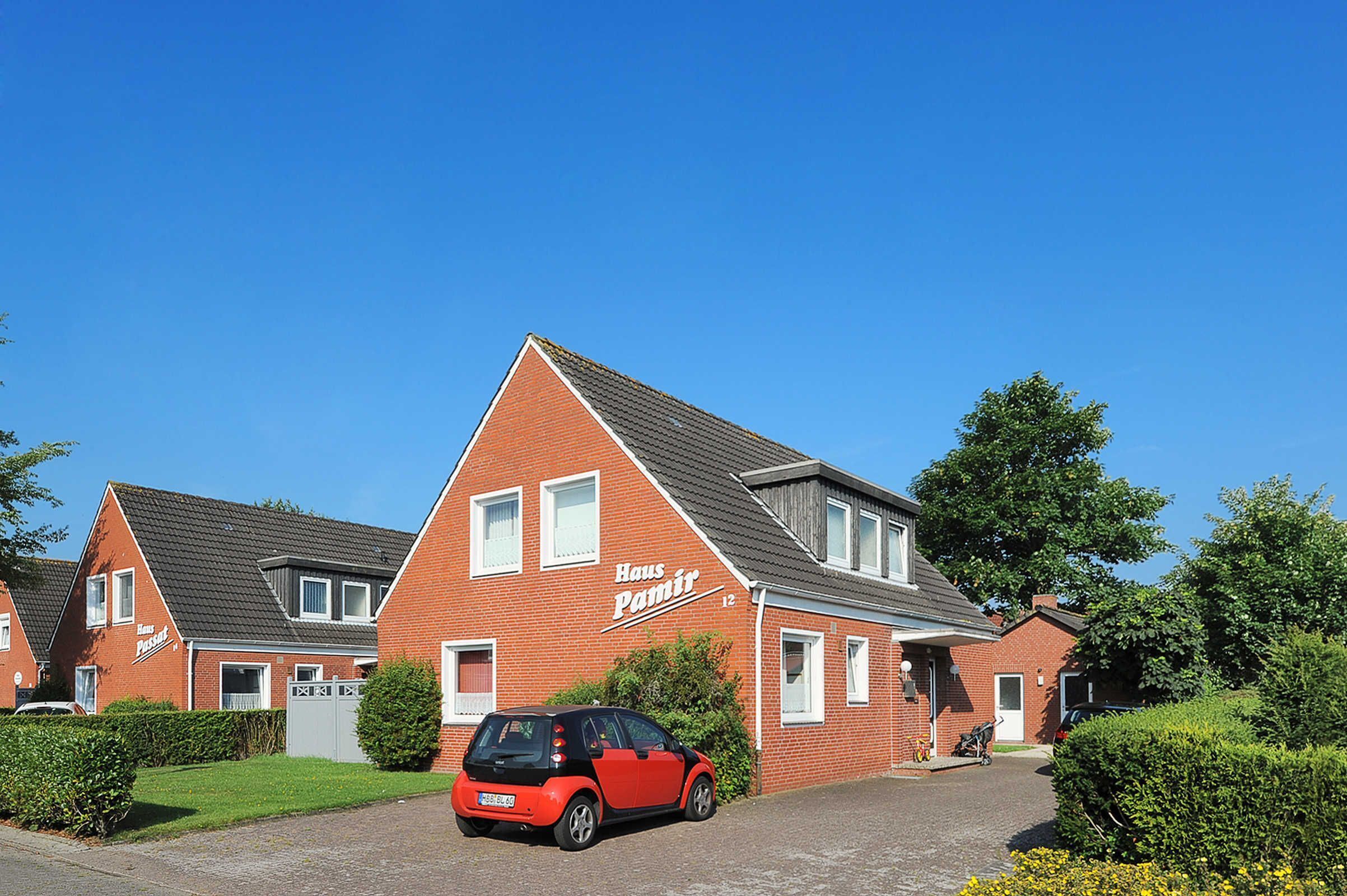 A red brick house with the sign "Haus Pamir" on the front.