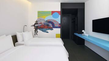 A modern hotel room with two beds, a flat-screen TV, a desk with a lamp, and a colorful abstract painting on the wall.
