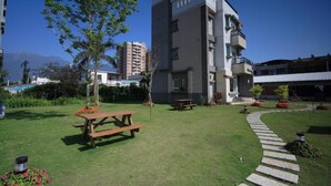 A modern building with a flat roof, a balcony, and a paved pathway leading to the entrance. - Happiness Garden (Ji'an)