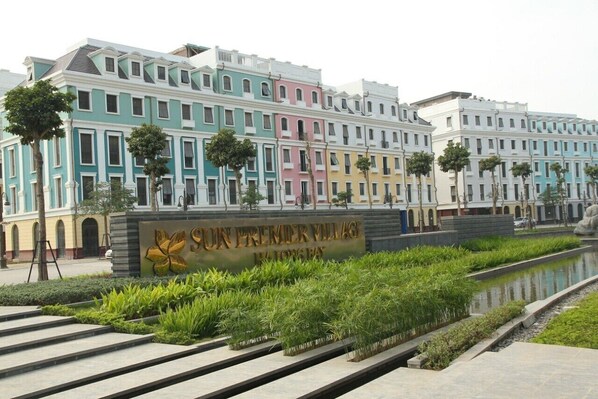 A multi-story building with a sign reading "SUN PREMIER VILLAGE."