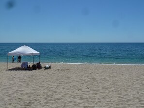 On the beach, sun-loungers