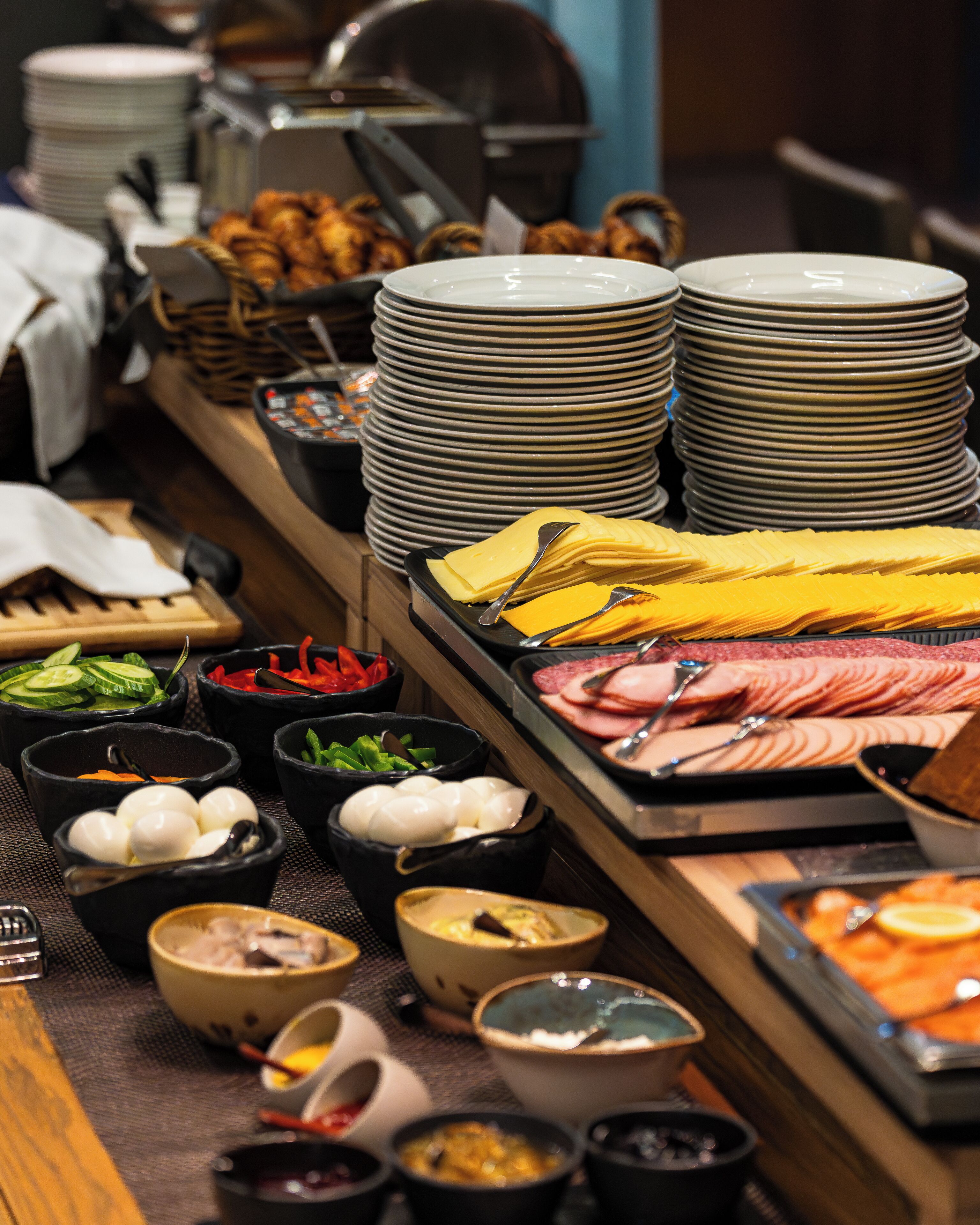 A buffet with various food items and dishes.