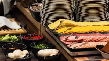 A buffet with various food items and dishes.