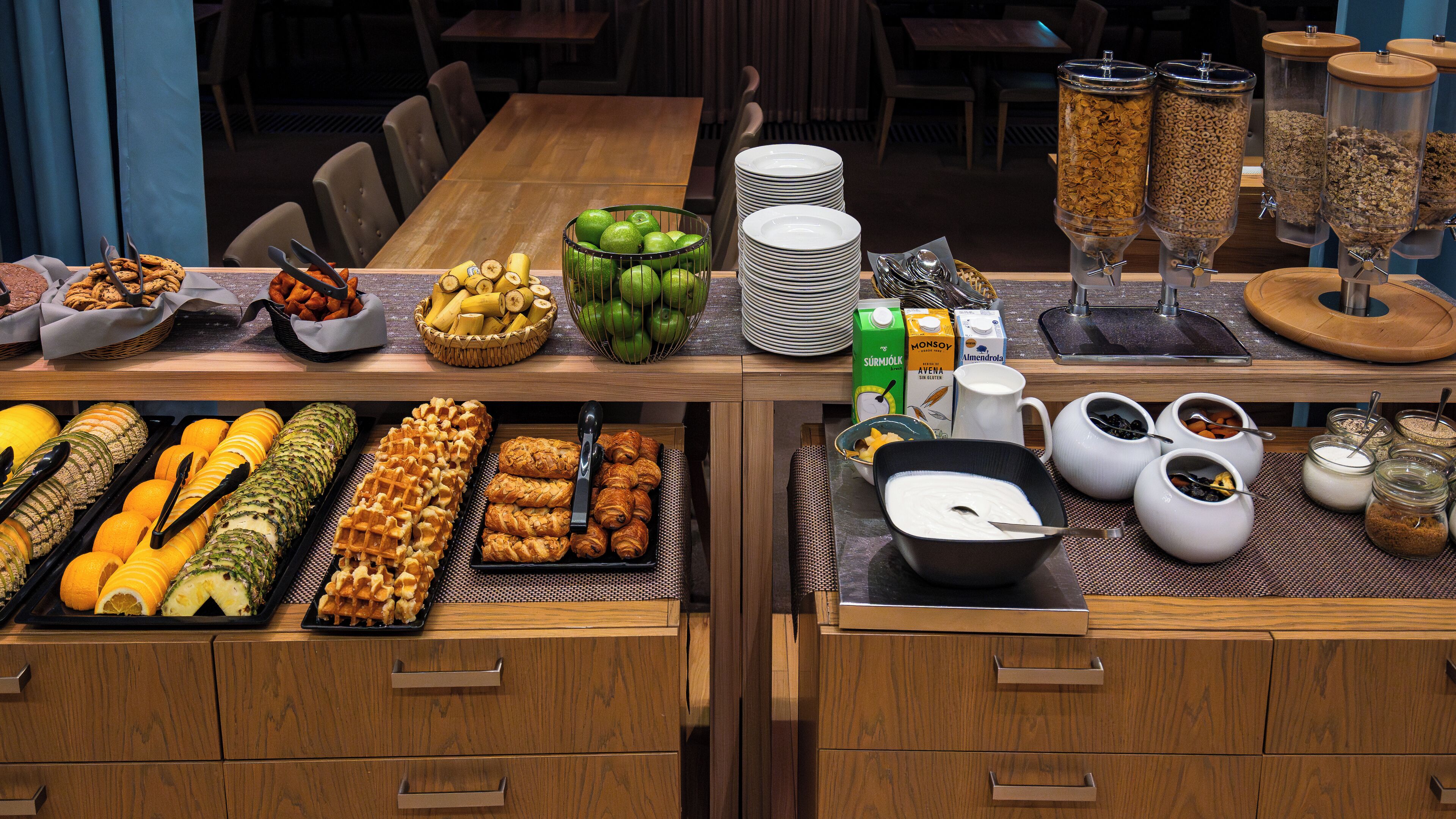 A buffet setup with various food items and beverages.
