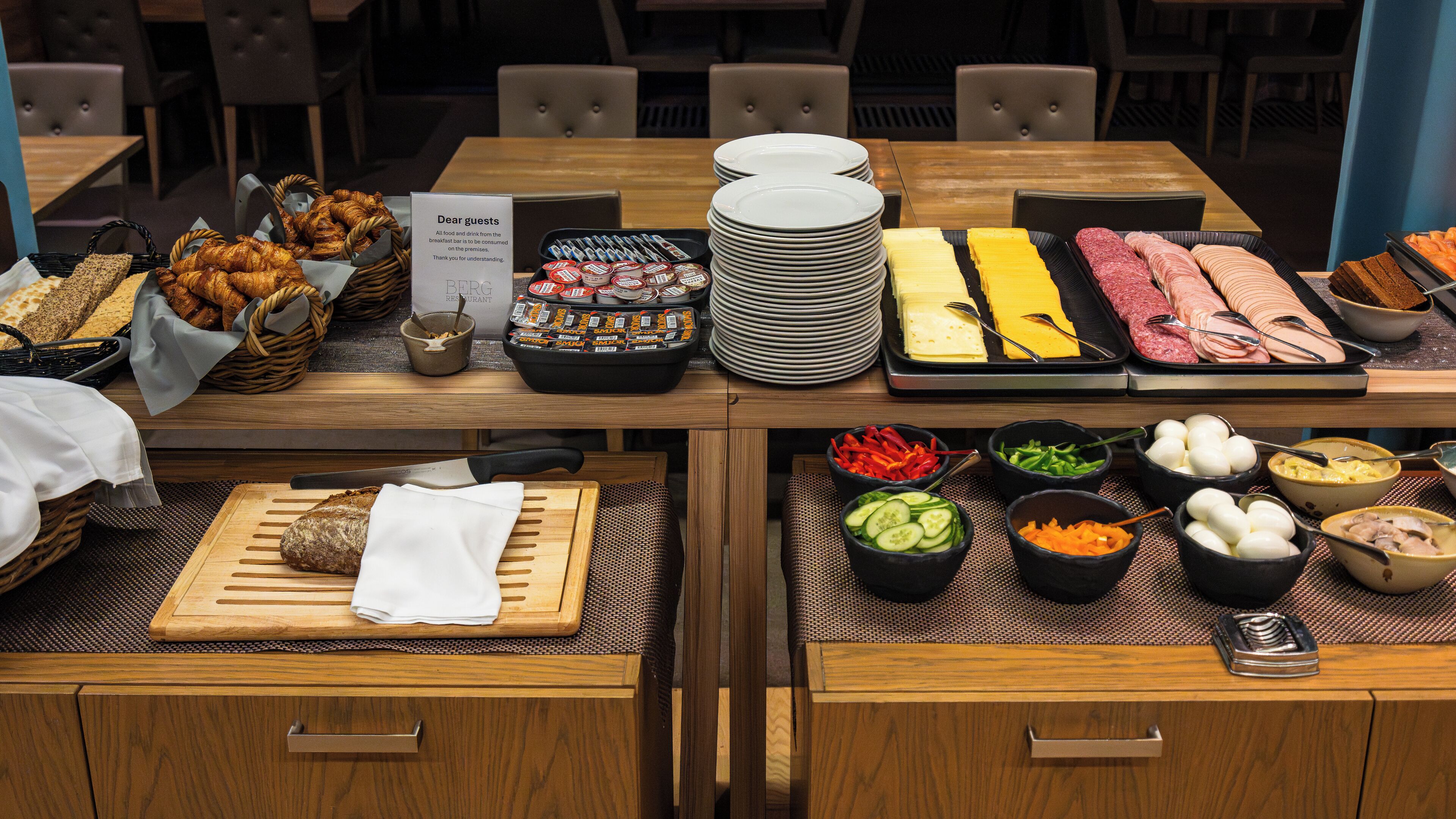 A buffet setup with various food items and utensils.