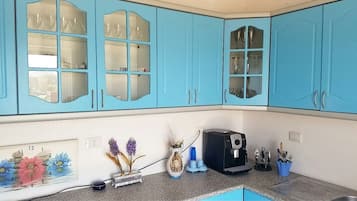 Fridge, coffee/tea maker, cookware/dishes/utensils