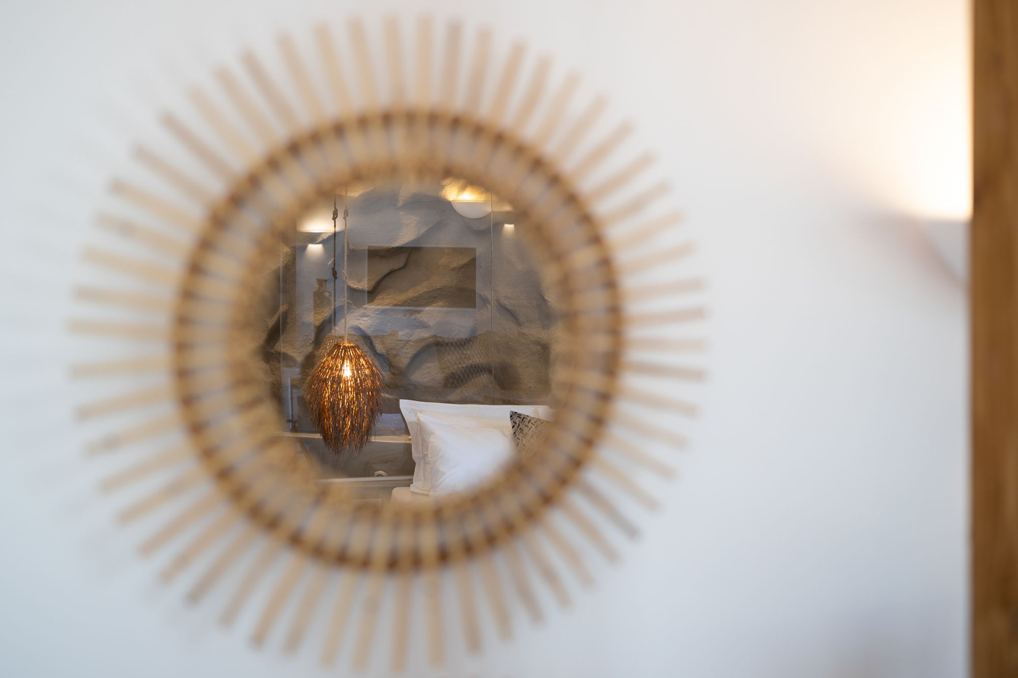 A circular wall decoration with a central reflective element and a textured background.