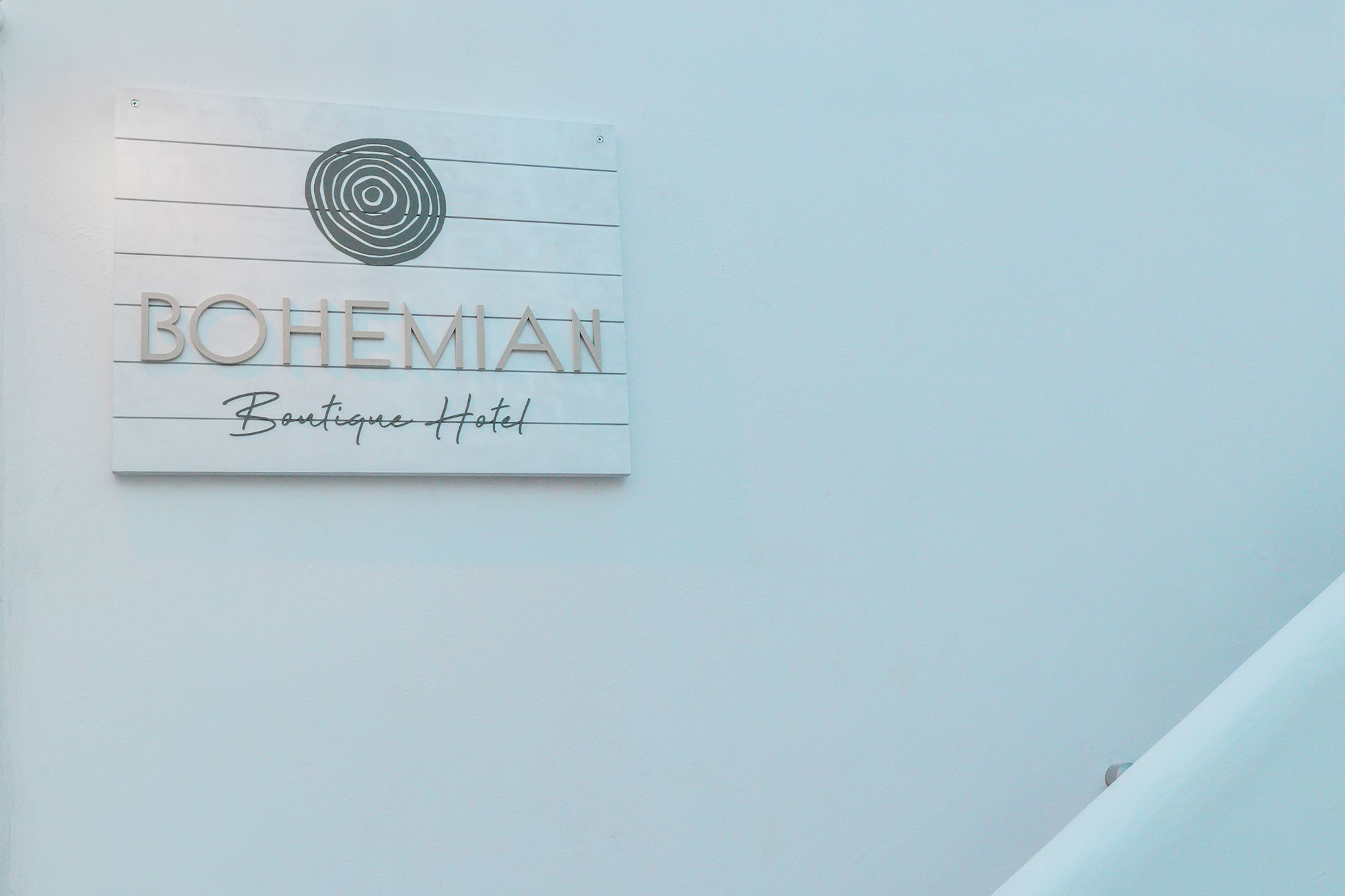 A sign for Bohemian Boutique Hotel with a circular design element above the text.