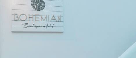A sign for Bohemian Boutique Hotel with a circular design element above the text.