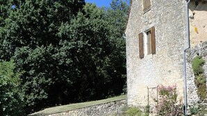 A stone building with a swimming pool and a blue cover. - 2 Beautiful country houses fully restored - stunning view                 (Dordogne)