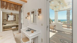 A bathroom with a white vanity, a large mirror, and a view of the outdoors. - Glaronissi Beach (Naxos)