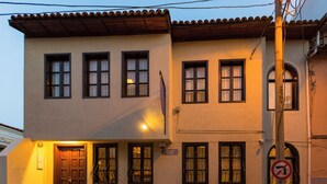 A two-story building with a flat facade, a set of stairs leading to the entrance, and a no parking sign visible on the right. - Old Town Boutique Hotel (Kusadasi)