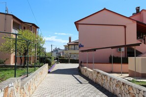 Stroll down this charming residential street lined with lush greenery and picturesque buildings.