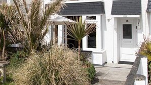 A white two-story house with a visible door number 15.