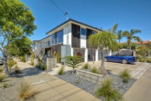 Stunning two-story home with a covered driveway and lush front yard.