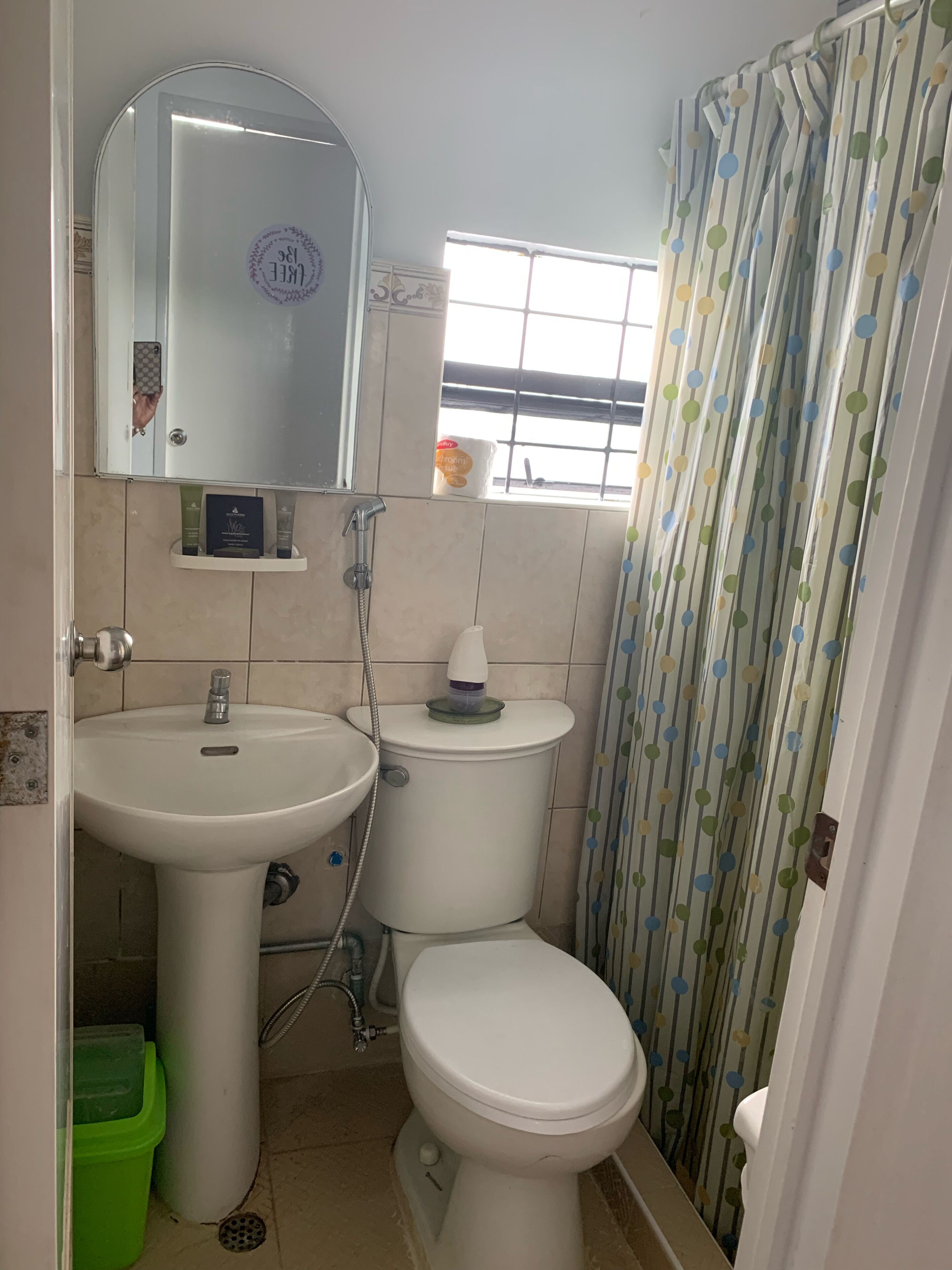 A bathroom with a sink, toilet, and shower curtain.