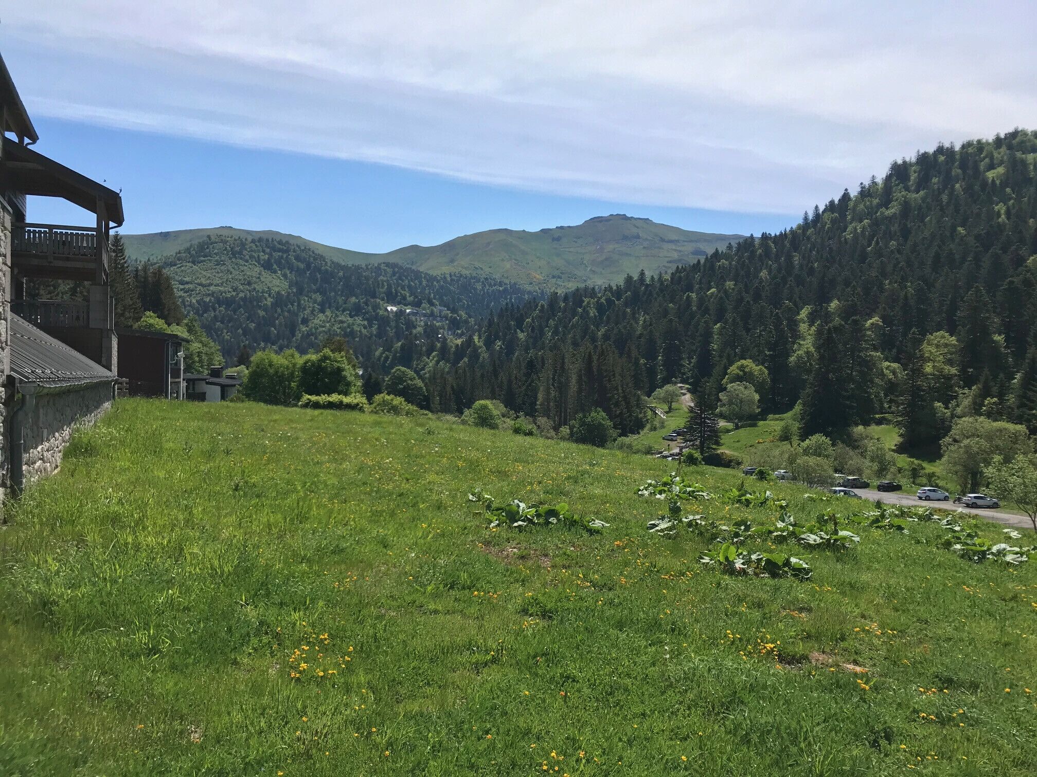 A mountainous landscape with a building on the left.