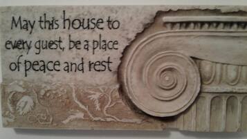 A decorative piece with a quote about peace and rest, and a classical column design.