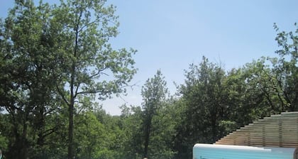 Modern wooden house with tree terrace and private heated pool
