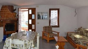 A compact living space with a kitchen, dining area, and seating area.