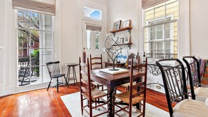 A dining area with a wooden table, chairs, and a chandelier. - New Orleans charm with Gated Parking! (New Orleans)