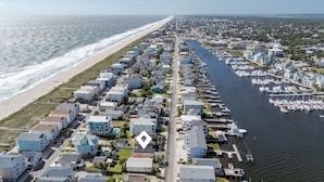 An aerial view of a coastal residential area with houses, a marina, and a beach. - 710 Canal Upper - Make Everyday a Holiday! (Carolina Beach)