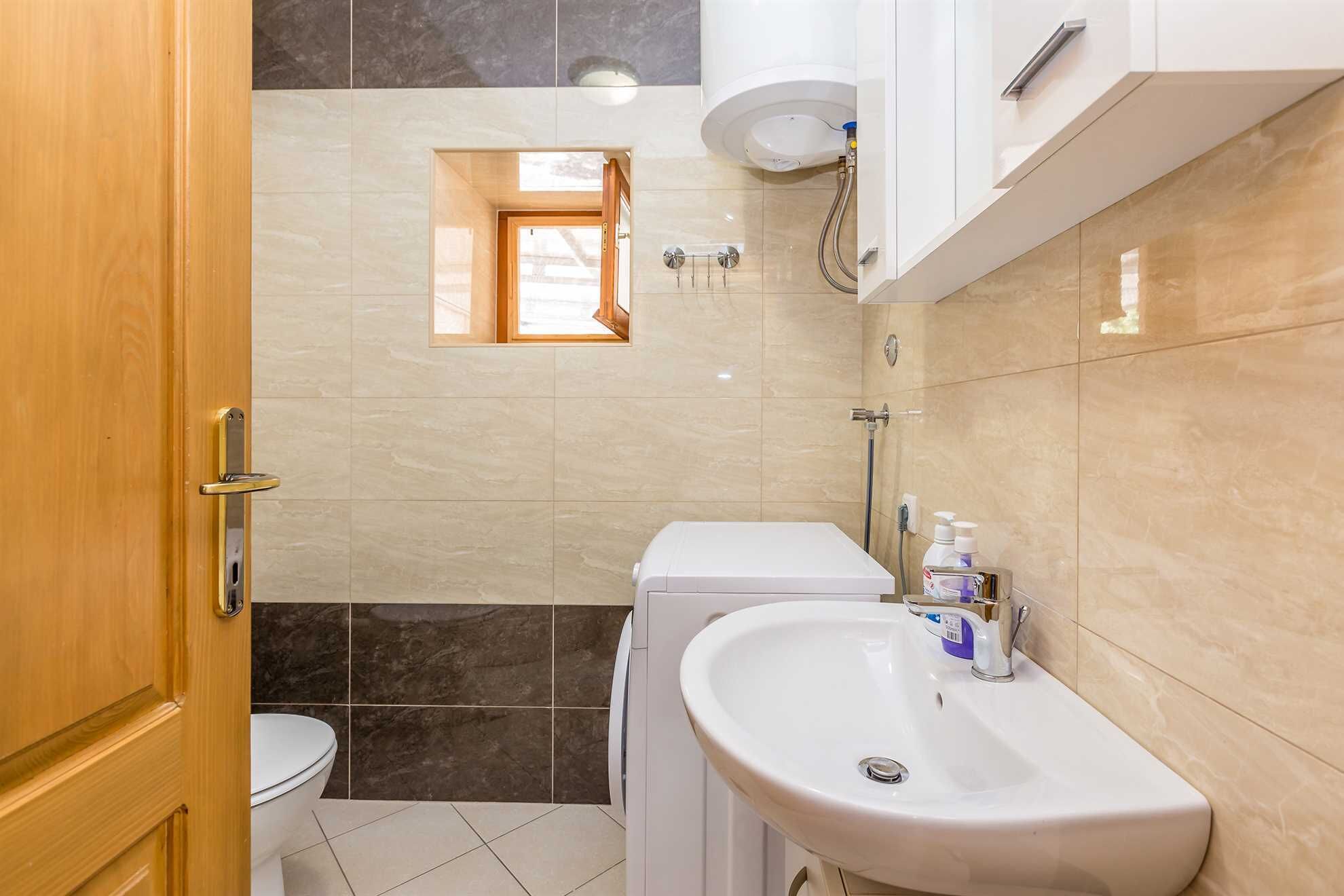A bathroom with a toilet, a sink, and a shower.
