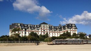 A large, multi-story hotel with a traditional European architectural style, featuring balconies and a prominent sign. - House with garden, 8 minutes Beach LA BAULE, residence with swimming pool (Guérande)