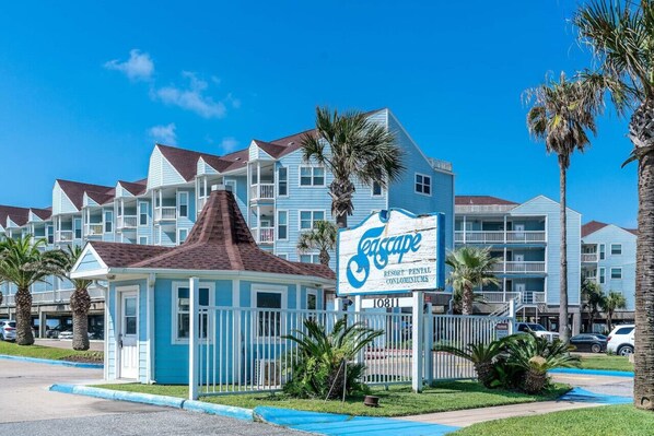 A resort with a sign reading "Seascape Resort Rental Condominiums." - Steps to Pool and Beach...Amazing Views from Two Balconies! (Galveston)