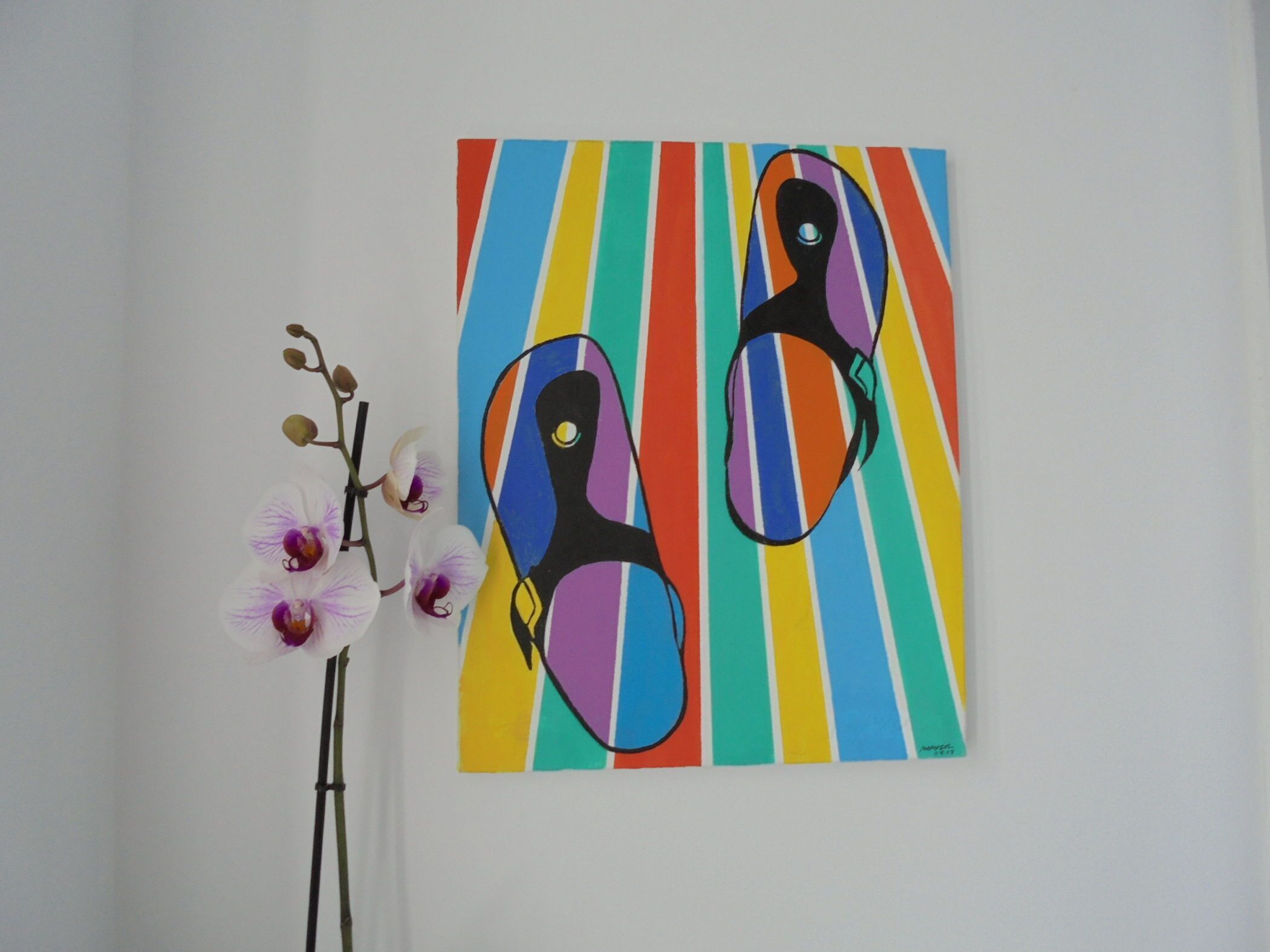 A painting of abstract figures on a colorful striped background.