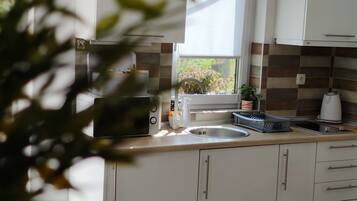 Fridge, microwave, stovetop, coffee/tea maker