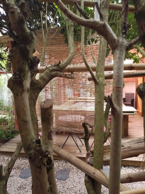 Escape to a serene garden oasis with a wooden structure amidst lush trees.