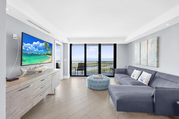 Condo, 1 King Bed with Sofa bed (Elegant beachfront condo in private c) | Living area | Flat-screen TV
