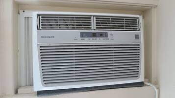 A white air conditioner unit with a control panel labeled "FRIGIDAIRE" and buttons for "timer," "mode," "on-off," "fan speed," and "sleep."