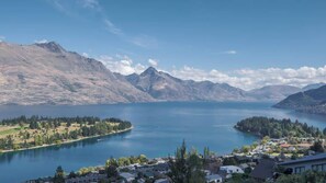 A lakeside view with mountains in the background, a small town with houses and greenery in the foreground. - Elevated views Lookout Point No 7 (Queenstown)