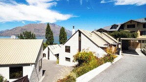 A residential area with houses, a clear sky, and mountains in the background.