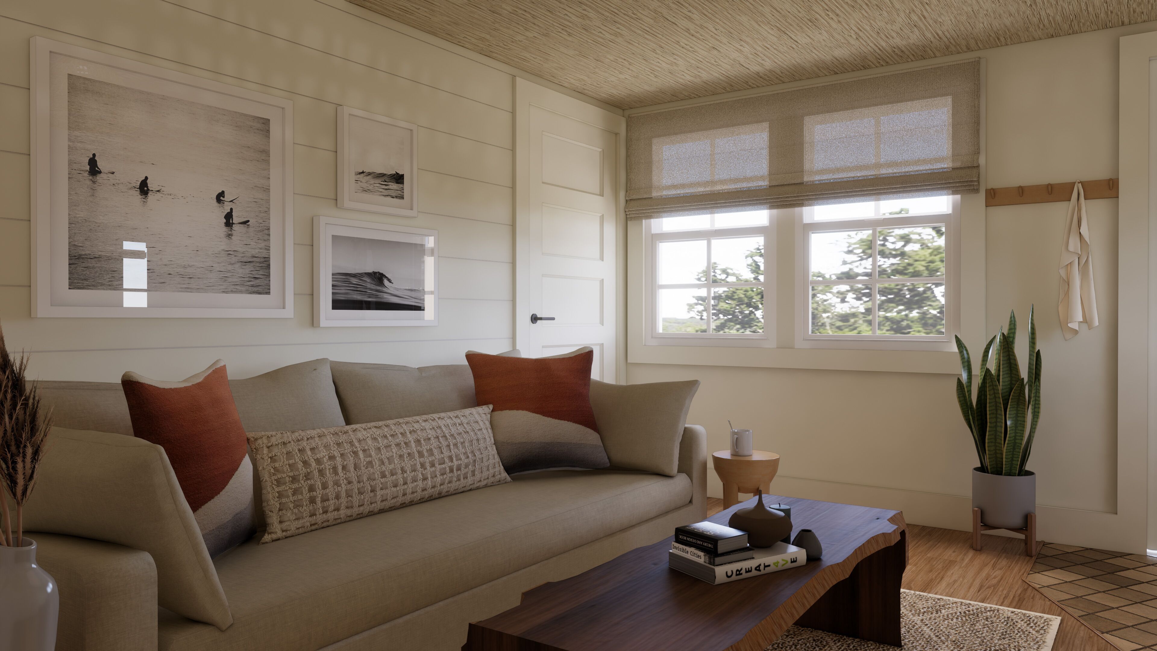 A living room with a beige sofa, a wooden coffee table, and framed artwork on the wall.
