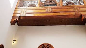 Traditional architecture meets elegance with a high ceiling and ornate balcony.