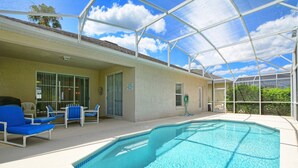 A covered outdoor swimming pool with lounge chairs and a clear view of the sky. - Esprit 603 (Davenport)