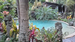A tropical garden with a pool, stone statues, and lush greenery. - Alaya Ascend  |  Seminyak Pool-view Room |  Sunshine Coast Retreat (Eudlo)