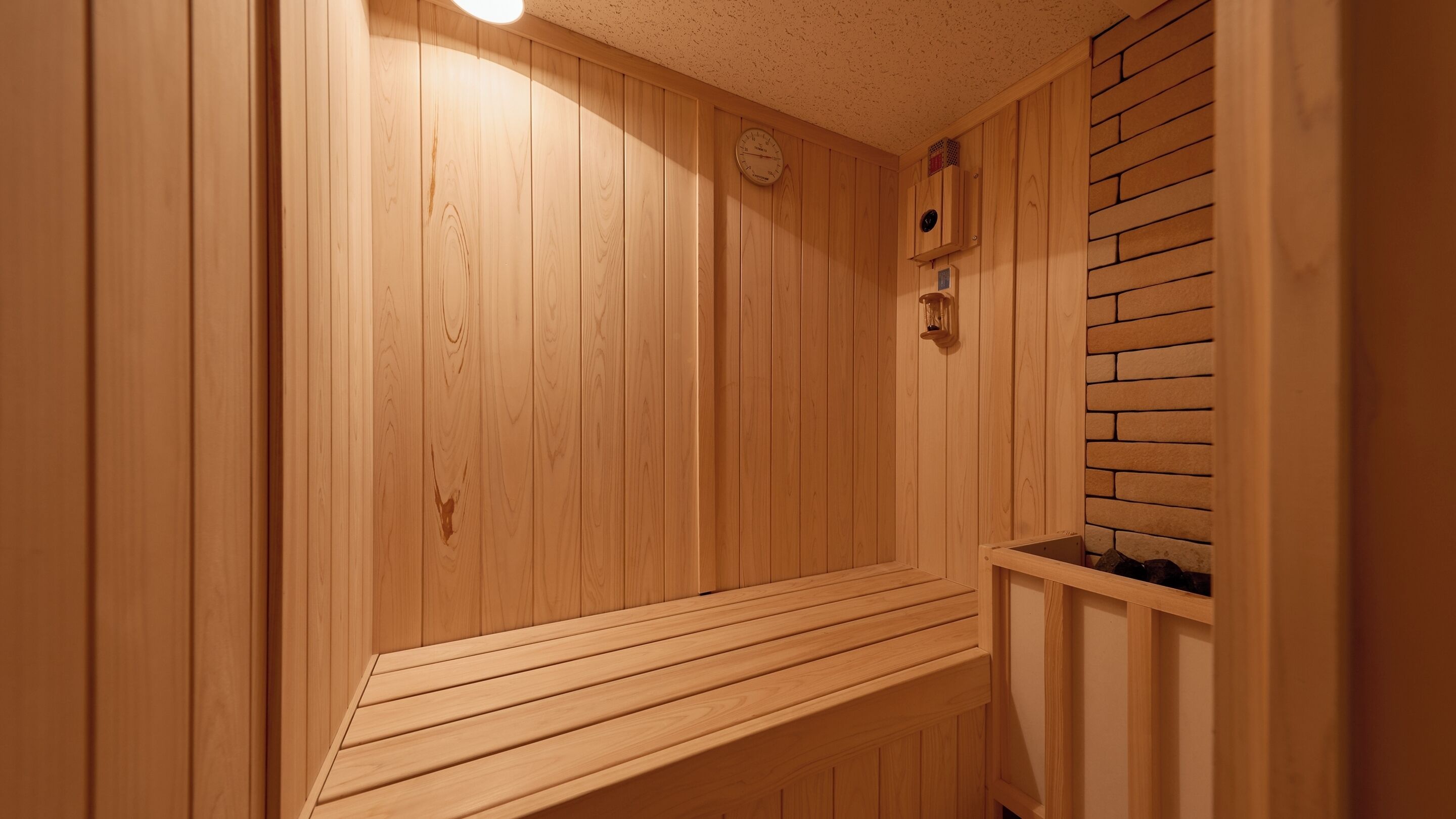A sauna with wooden walls and a bench.