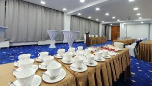 A conference room with tables set for a meeting, equipped with microphones and a projector. - UB Grand Hotel (Ulaanbaatar)