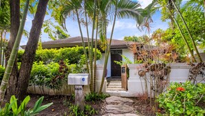 A house with a front yard, a mailbox, and a pathway leading to the entrance. - Phuket Ratchamaka Pool Villa (Chalong)