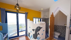 A room with a balcony, a dolphin-themed reception desk, a shower area, and a toilet. - Haisu Homestay (Hengchun)