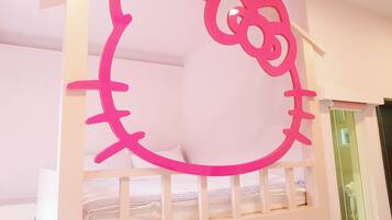 A bunk bed with a Hello Kitty design on the headboard.
