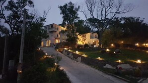 A two-story building with a stone pathway leading to the entrance. - Moonshine B&B (Touwu)