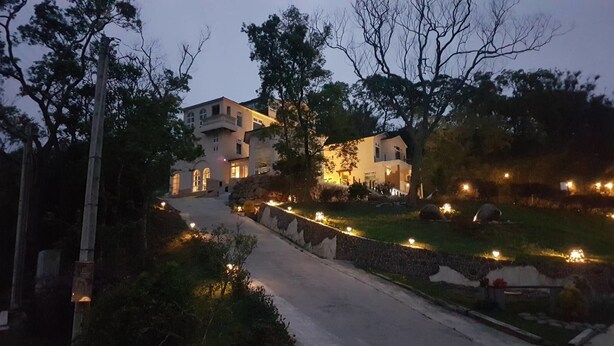 A two-story building with a stone pathway leading to the entrance. - Moonshine B&B (Touwu)